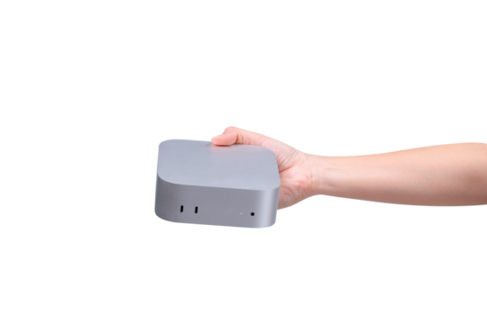 A hand holding a compact mini PC or portable computer isolated on a transparent background.