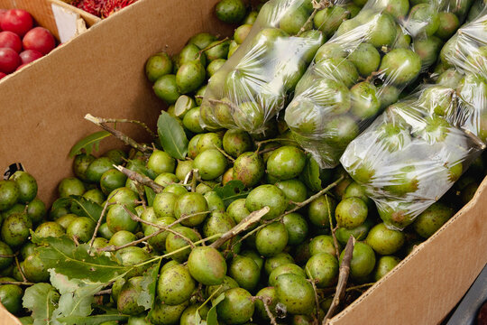 Fresh Spanish limes (mamoncillos) for sale at a local market