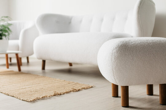 Minimalist Scandinavian living room with white boucle sofa and armchair