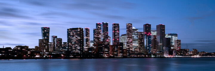 Naklejka premium Panorama view across the River Thames from North Greenwich to Canary Wharf skyline in early evening