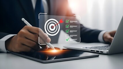Businessman analyzing data on tablet with target graphic and laptop nearby