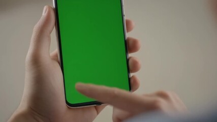 Person using smartphone with a green screen for advertising or marketing campaigns