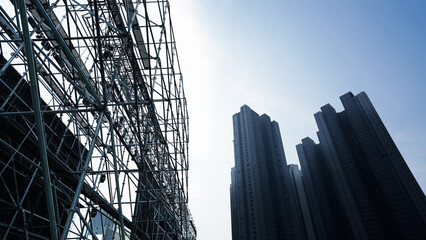 Industrial stage framework juxtaposed with tall residential buildings