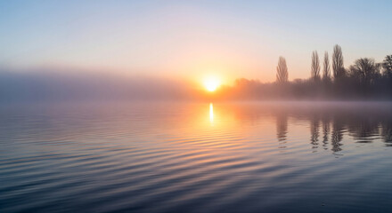 Morning fog on lake in the rays of the rising sun