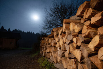 Stacked firewood full moon night cottage rural