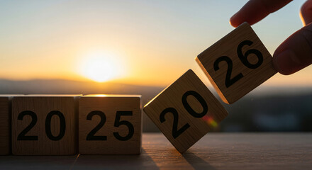 Goals moving forward to 2026, road to next, numbers on wooden box on blue background.,Entering 2026