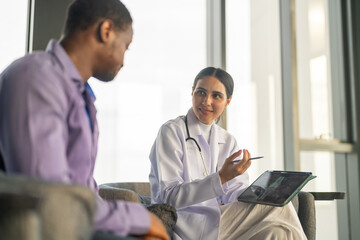 Doctor comforting depressed man during mental health consultation, showing empathy emotional...