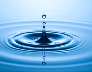 A water droplet impacting a tranquil surface, creating ripples