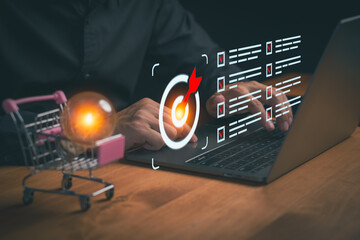 Person working on laptop with digital target icons, checklist elements, and a search idea, representing e-commerce strategy, sales, marketing optimization, business planning, and online goal setting.
