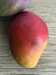 A sweet, fragrant, fiberless mango with smooth flesh. Its green skin turns reddish when ripe, giving it the look of an apple mango.