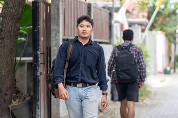 Two Asian men saying goodbye outdoors after work