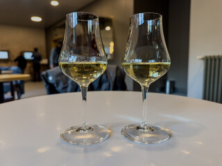 Two glasses of white wine on table in modern bar