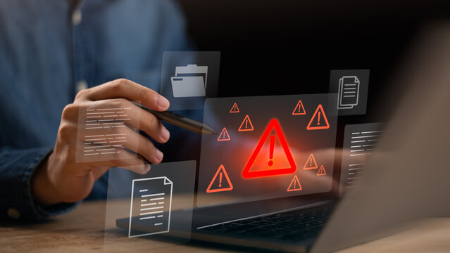 digital warning alert displayed on laptop with document icons, representing system risk, data threat, cyber alerts, file security issues, online protection challenges in modern digital environments.