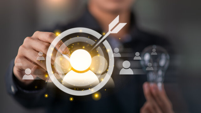 marketer selecting target customer icon with digital targeting interface, illustrating customer segmentation, personalized marketing, audience analysis, strategic decision-making for business growth.