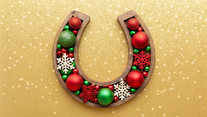 christmas greeting card  A wooden horseshoe is adorned with red and green ornaments, snowflakes, and shiny beads