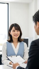 Young Japanese Woman Smiling During Job Interview Holding Clipboard.