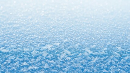 A close-up of a snowflake on a cold, snowy surface.