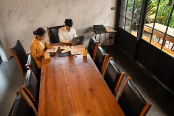 Asian Office Workers Collaborating in a Business Meeting.