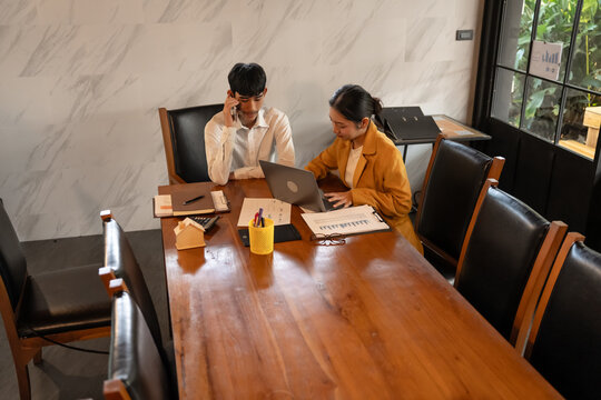 Asian Office Workers Collaborating in a Business Meeting. - Powered by Adobe
