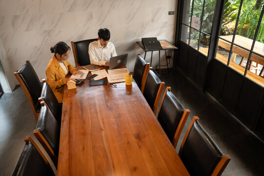 Asian Office Workers Collaborating in a Business Meeting.
