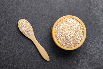 Wooden bowl and spoon filled with quinoa seeds