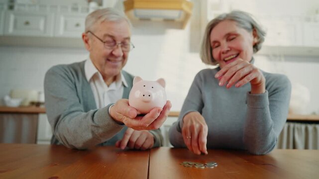 Grey-haired lady putting coins into piggy bank, aged husband holding moneybox. Elderly people saving money for future, financial literacy and care about future, incomes, salary and pension savings