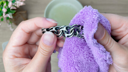 Silver jewelry is carefully wiped with a cloth after cleaning, polishing the surface and enhancing...