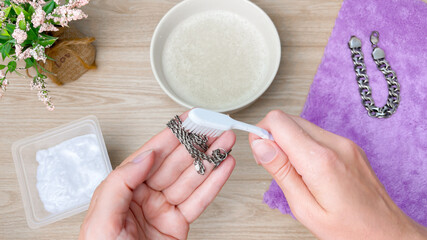 Clean tarnish off a silver chain with a small brush and soapy water. A homemade silver care method.
