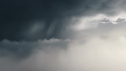 Dramatic dark storm cloud with heavy rain shaft descending through thick white fog or low cloud cover from above - Powered by Adobe