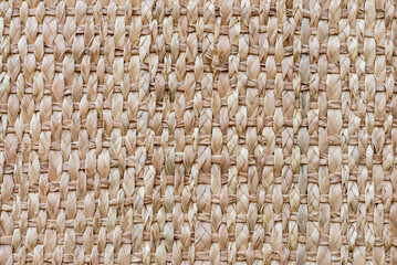 Detailed closeup of a woven basket surface, showcasing the natural texture and intricate pattern of the weaving.