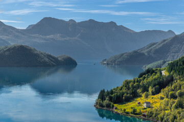 Panoramic View of a Calm Norwegian Fjord Surrounded by Mountains and Forests