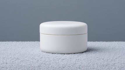 Minimalist skincare jar placed on soft surface in calming tones, inviting relaxation and self-care routines. National Winter Skin Relief Day