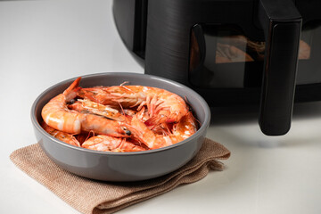 Deep-fried shrimp taken out of the air fryer.