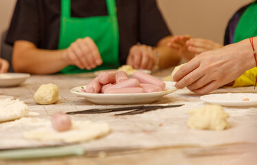 A plate of hot dogs is on a table
