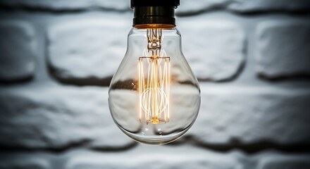 Illuminating the Essence: A Close-Up of a Glowing Vintage Light Bulb Against Brick Wall