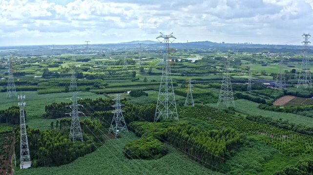 Power Grid Transmission Towers Over Farmland in Zhanjiang, Southern China - Aerial View