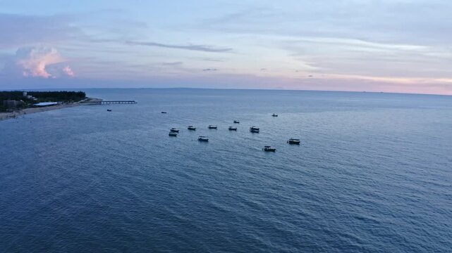 Fishing Boats at Sunset in Zhanjiang Xuwen Seaside Waters, China - Aerial Ocean View with Dramatic Twilight Sky