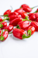Vibrant red jalapeno pepper on a white background with space for text, ideal for food and culinary concepts.Group of ripe red jalapeno peppers .