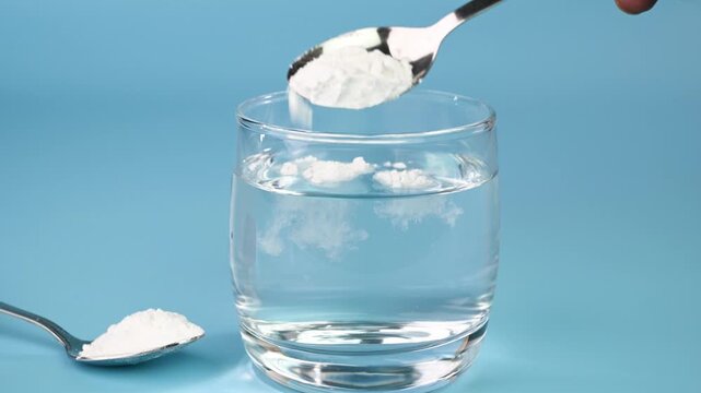 Mixing baking soda in water.
