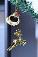 christmas bell and angel on the tree, closeup of photo