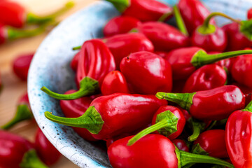 Vibrant red jalapeno pepper on a white background with space for text, ideal for food and culinary concepts.Group of ripe red jalapeno peppers .