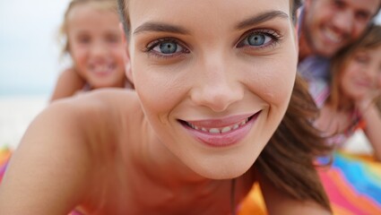 Close-up smiling mother with children in soft-focus family beach portrait