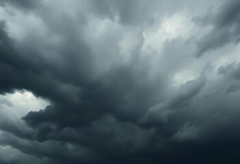 Obraz premium Ominous, swirling dark grey and black storm clouds fill the frame, dark, intense
