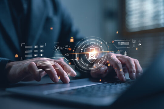 Cybersecurity concept with businessman working on laptop and virtual lock icon interface. Data protection, secure connection, digital privacy and network safety technology.