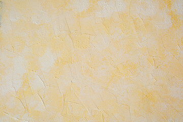 Yellow stucco wall with soft plaster texture and pastel surface