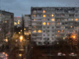 Rainy evening outside the window in the style of bokeh (blurred)