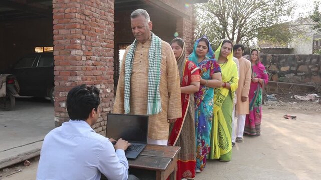 Rural indian people standing in a queue to get their documents verified to get benefits of government scheme.