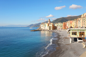 View of sea and coast on sunny day. Fishing village, Camogli, Italy. Tourism and recreation. Ecologically clean nature. Traditional old buildings. Historical centre.