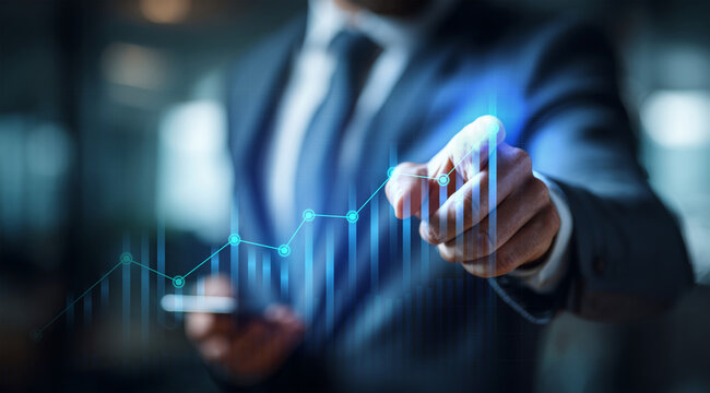 Businessman touching a glowing line graph overlaying a bar chart, symbolizing financial growth, excellent business performance, and rising market success. - Powered by Adobe