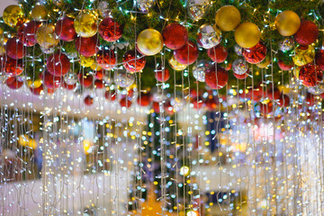 Beautiful hanging Christmas ornaments and sparkling fairy lights decoration for festive celebration...